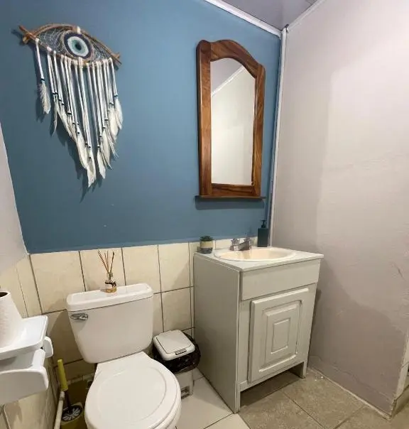 Full view of the girls' hostel bathroom, clean, with blue wall and tiles.