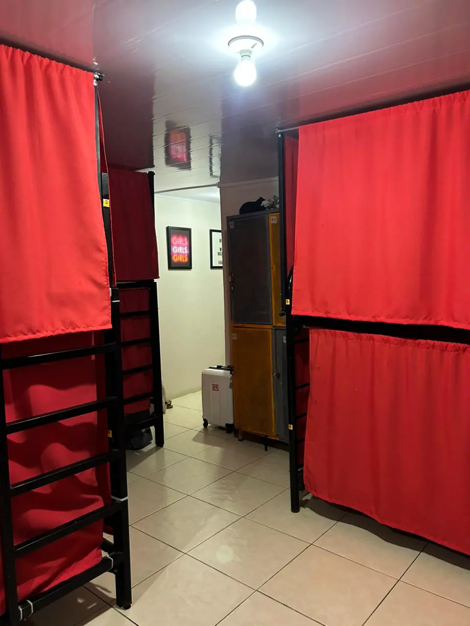 Girls' room with private beds and view of the aesthetic hallway.